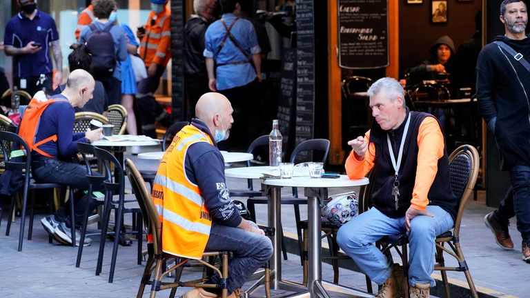 Diners eat outside at a cafe on the first day of lockdown lifting
