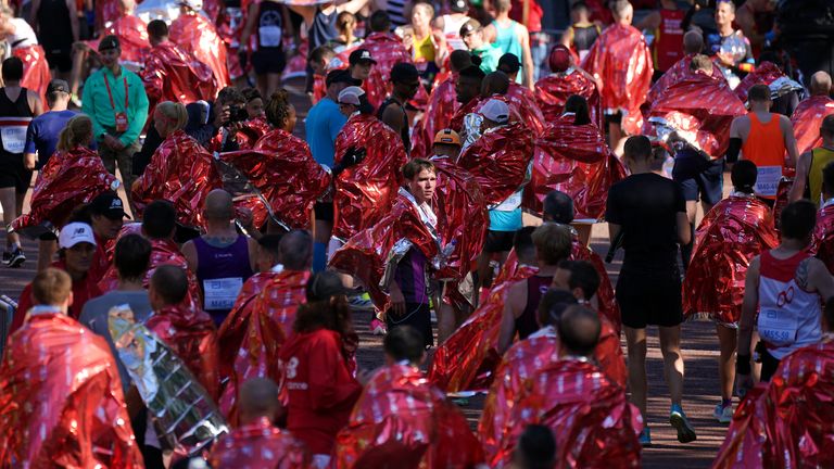 Runners wrapped in foil blankets after finishing the Virgin Money London Marathon