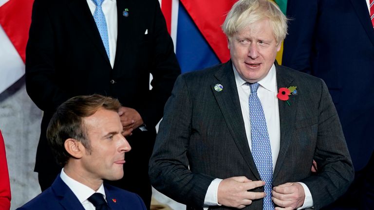 Boris Johnson and Emmanuel Macron prepare for the official photos to be taken at the G20 summit in Rome