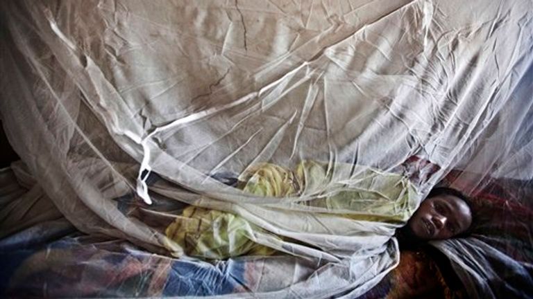 A female malaria patient is pictured under a net in El Sereif, Sudan. Pic: AP
