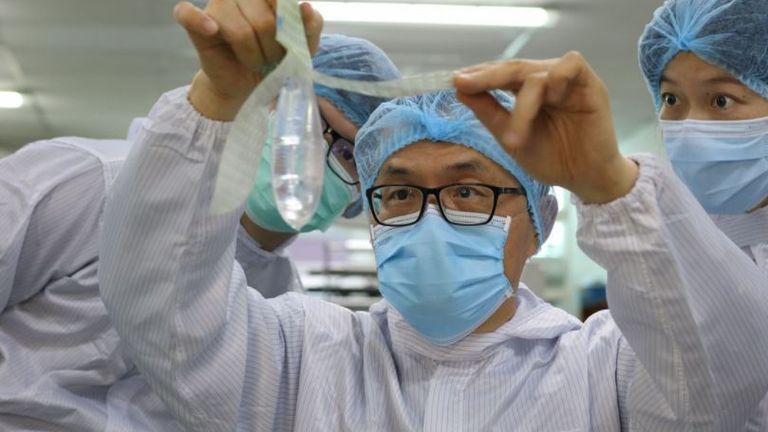 Founder and inventor of Wondaleaf Unisex Condom John Tang Ing Ching inspects the unisex condom at his factory in Sibu, Malaysia October 19, 2021. Twin Catalyst/Handout via REUTERS



