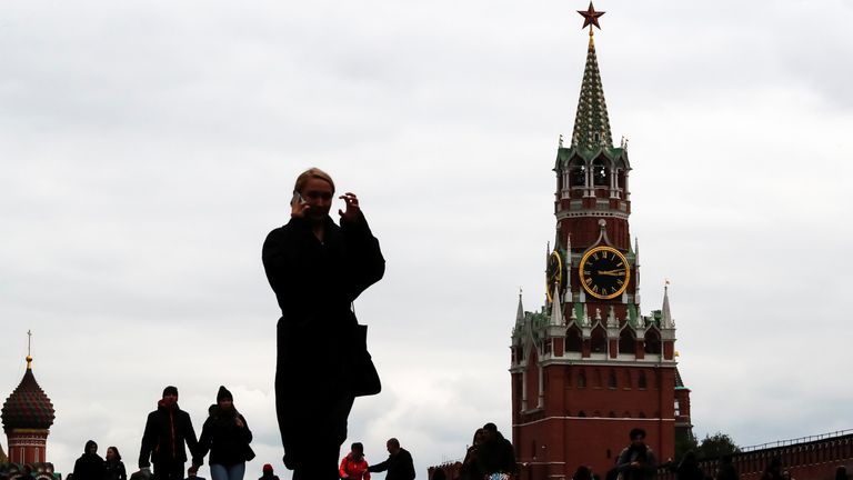 People walk across Red Square in Moscow