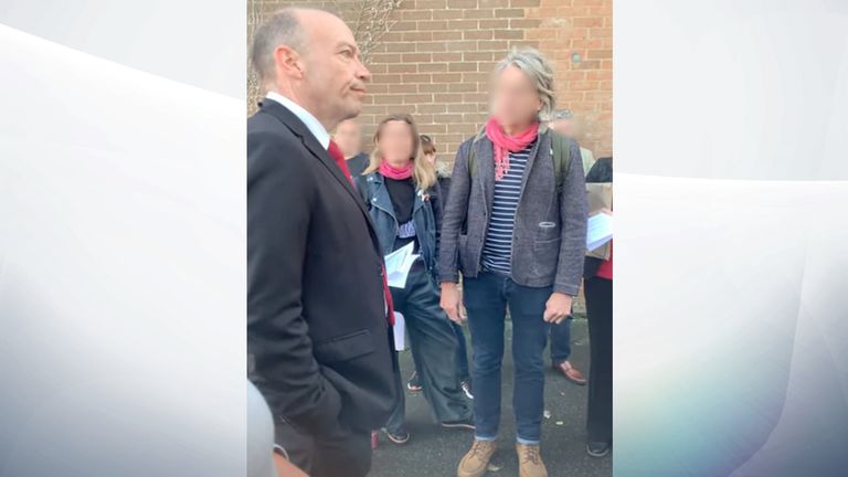 Chris Heaton-Harris, a Conservative minister, spoke with a large crowd and asked people not to go to his family home