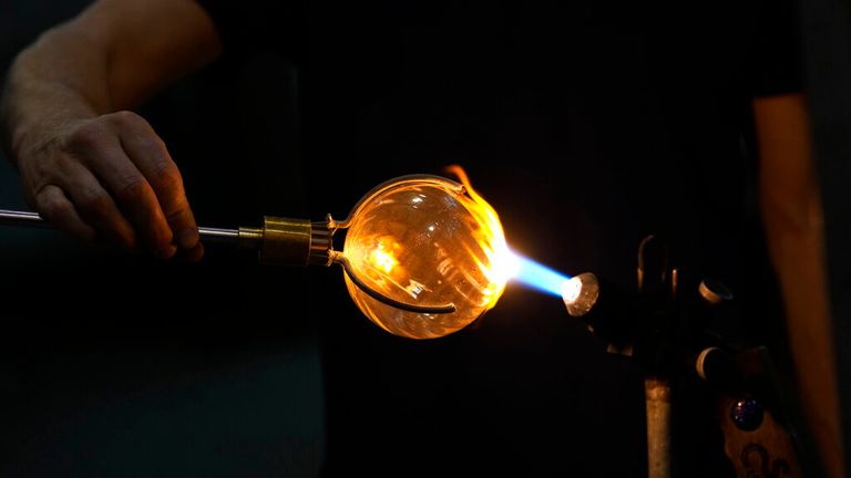 A glass-worker gives the last touch to a glass creation in a factory in Murano island, Venice. Pic: AP