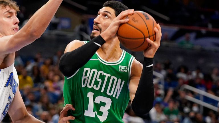 Boston Celtics&#39; Enes Kanter (13) attempts a shot against Orlando Magic&#39;s Franz Wagner, left, during the second half of an NBA preseason basketball game, Wednesday, Oct. 13, 2021, in Orlando, Fla. (AP Photo/John Raoux)