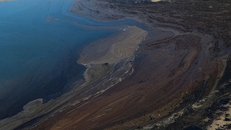 Oil washed up on Huntington Beach, Calif., on Sunday, Oct. 3, 2021. A major oil spill off the coast of Southern California fouled popular beaches and killed wildlife while crews scrambled Sunday to contain the crude before it spread further into protected wetlands. (AP Photo/Ringo H.W. Chiu)  
PIC:AP