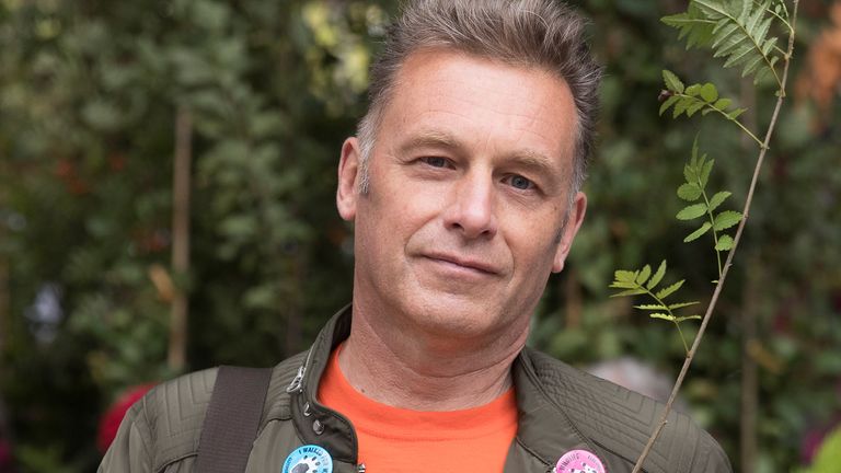 Television presenter and environmentalist Chris Packham holds a plant as he joins Extinction Rebellion and anti-HS2 protesters as they demonstrate outside the High Speed 2 headquarters at Euston Station in London, Britain September 28, 2019. REUTERS/Simon Dawson