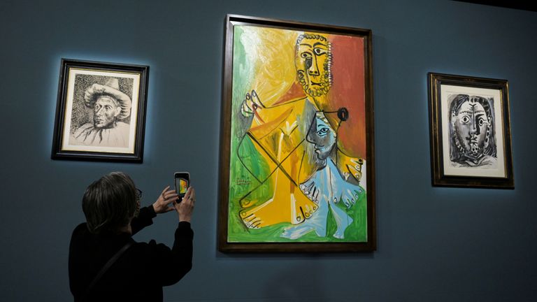 An attendee photographs a painting prior to the auction of 11 Picasso paintings and works at the Bellagio Hotel in Las Vegas, Nevada, U.S. October 23, 2021. REUTERS/Bridget Bennett