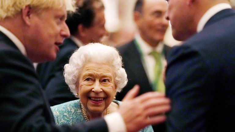 Britain&#39;s Queen Elizabeth and Prime Minister Boris Johnson greet guests at a reception for the Global Investment Summit in Windsor Castle, Windsor, Britain, October 19, 2021. Alastair Grant/Pool via REUTERS