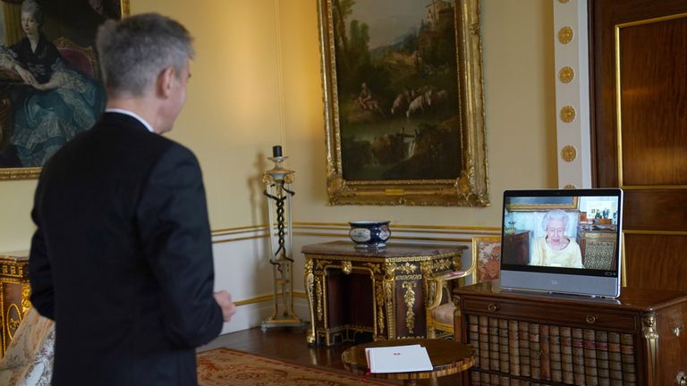 Queen Elizabeth II appears on a screen via videolink from Windsor Castle, where she is in residence, during a virtual audience to receive the as Ambassador from the Swiss Confederation, Markus Leitner at Buckingham Palace, London. Picture date: Tuesday October 26, 2021.
