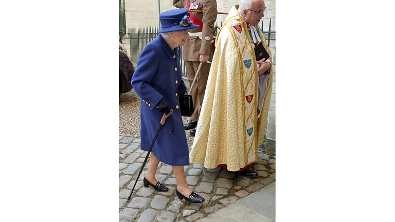 Queen Elizabeth II uses a cane as she arrives for Thanksgiving at Westminster Abbey in London to mark the Royal Legion's centenary.  Date taken: Tuesday, October 12, 2021.
