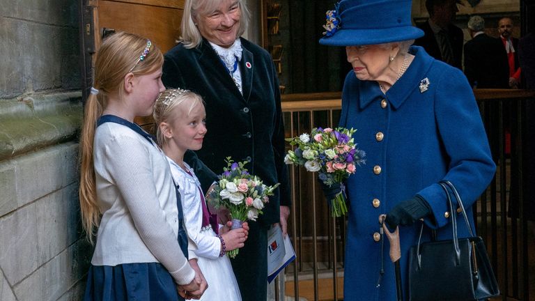 Queen Elizabeth receives flowers as she and Anne, Princess Royal, attend a Service of Thanksgiving to mark the Centenary of the Royal British Legion at Westminster Abbey, London, Britain October 12, 2021