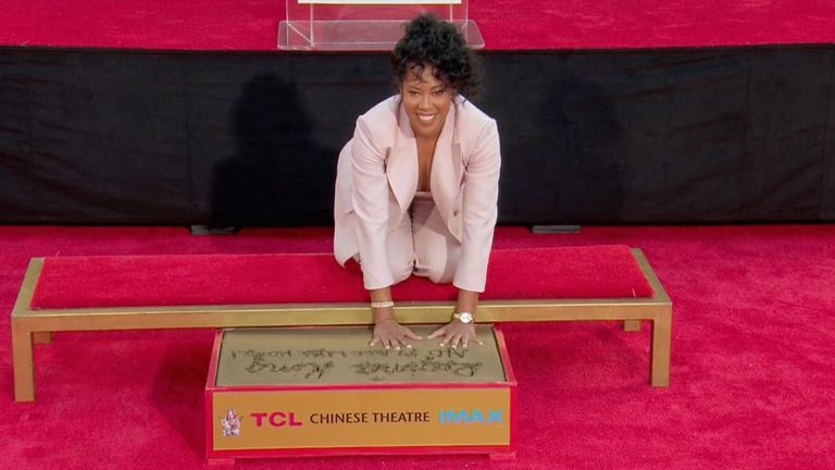 Oscar and Emmy-winning actress Regina King places her hand and footprints in cement in Hollywood tradition
