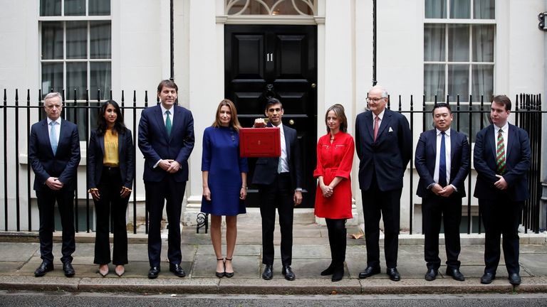 Britain&#39;s Chancellor of the Exchequer Rishi Sunak holds the budget box as he poses with his treasury team outside Downing Street in London, Britain, October 27, 2021. REUTERS/Peter Nicholls
