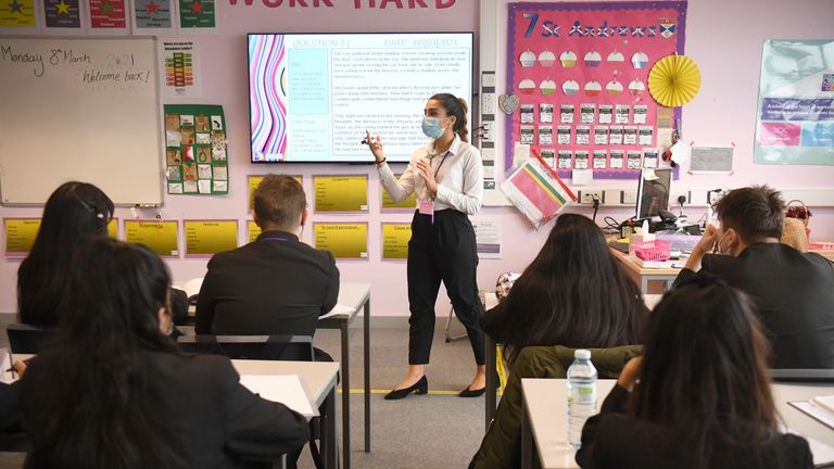 Children and the teacher wearing facemasks during a lesson at Hounslow Kingsley Academy in West London, as pupils in England return to school for the first time in two months as part of the first stage of lockdown easing. Picture date: Monday March 8, 2021.