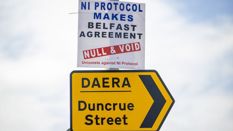 Anti NI Protocol sign above a sign for the Northern Ireland Department of Agriculture, Environment and Rural Affairs (DAERA) site on Duncrue Street in Belfast, which is one of the sites used when lorries roll off the ferries that is used to perform checks. Picture date: Monday June 28 2021.