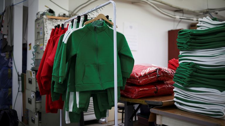 Costumes hang on a rail in the factory