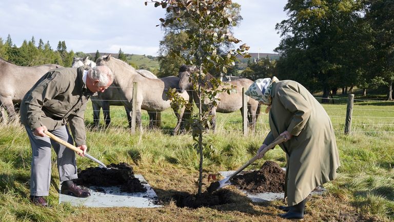 Queen Elizabeth II and Prince of Wales plant a tree at Balmoral Cricket Pavilion to mark the start of the official planting season for the Queen&#39;s Green Canopy (QGC) at the Balmoral Estate. Picture date: Friday October 1, 2021.
