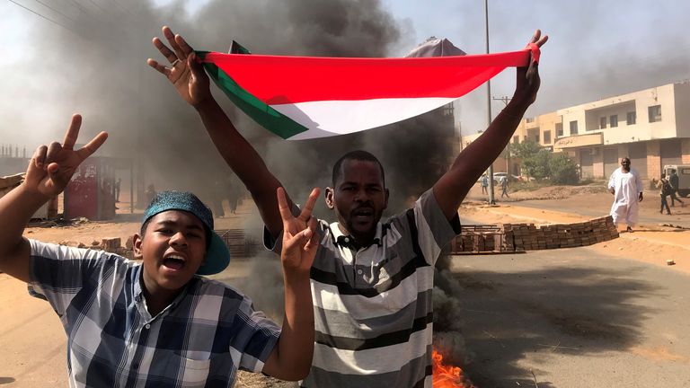 A protester waves a flag during what the information ministry calls a military coup in Khartoum, Sudan, October 25, 2021. REUTERS/Mohamed Nureldin Abdallah
