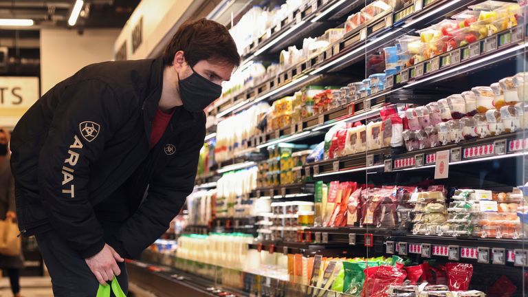 FILE PHOTO: A customer looks at the products at the UK&#39;s first Amazon Fresh supermarket, in London, Britain March 4, 2021. REUTERS/Henry Nicholls/File Photo