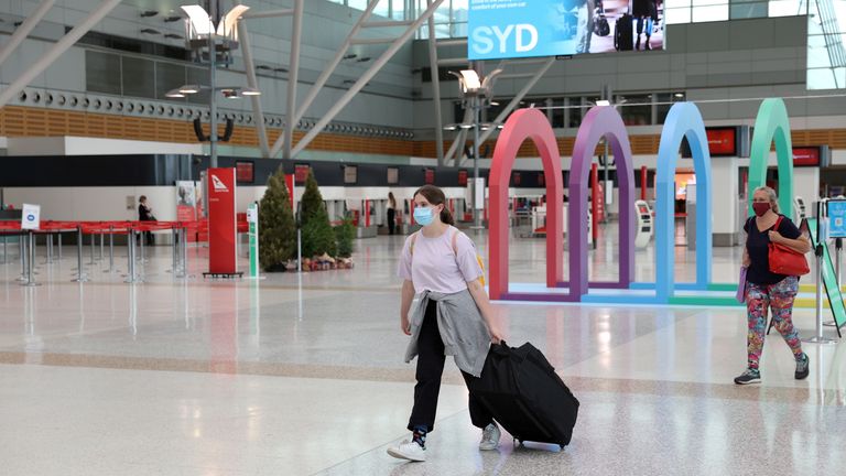 FILE PHOTO: People walk through the domestic terminal at Sydney Airport in Sydney, Australia, December 21, 2020. REUTERS/Loren Elliott/File Photo