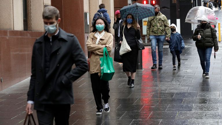People filter into the city after more than 100 days of lockdown to help contain the COVID-19 outbreak in Sydney, Monday, Oct. 11, 2021. (AP Photo/Rick Rycroft)