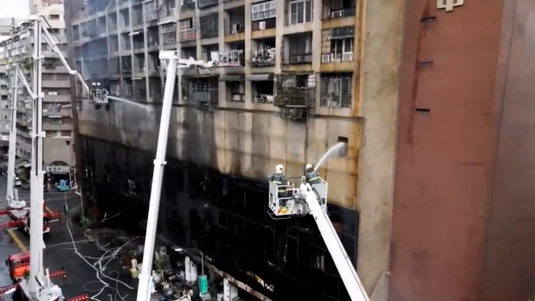 In this image taken from video by Taiwan's EBC, firefighters shoot water into a building that caught fire in Kaohsiung, in southern Taiwan on Thursday, Oct. 14, 2021. The fire engulfed a 13-story building overnight in southern Taiwan, killing some and injuring dozens, the island...s semi-official Central News Agency reported Thursday.  (EBC via AP )