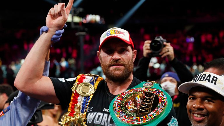 Tyson Fury celebrates with the belts after winning the fight against Deontay Wilder