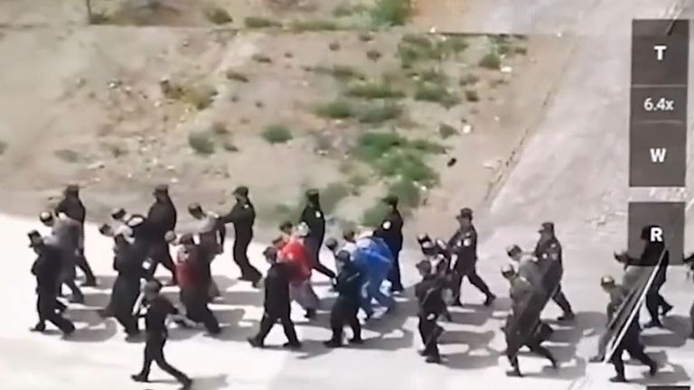 Alleged Uyghur prisoners are led away to detention camp