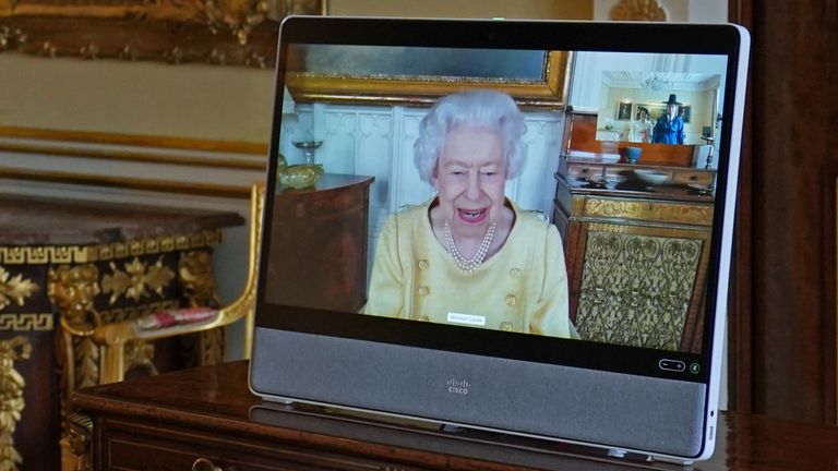 Queen Elizabeth II appears on a screen via videolink from Windsor Castle, where she is in residence, during a virtual audience to receive the Ambassador from the Republic of Korea, Gunn Kim, accompanied by HeeJung Lee (not seen), at Buckingham Palace, London. Picture date: Tuesday October 26, 2021.
