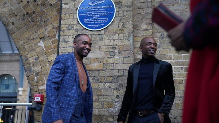 Relatives of Wilston Samuel Jackson, Britain&#39;s first black train driver, stand underneath a plaque to commemorate Jackson after it was unveiled at King&#39;s Cross in London. Picture date: Monday October 25, 2021.

