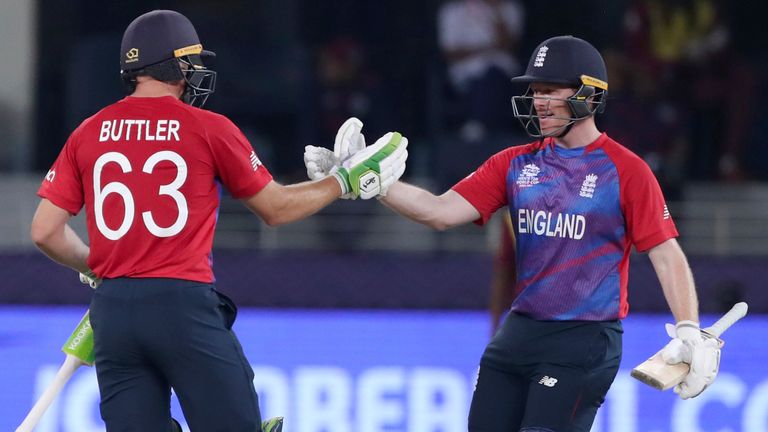 England&#39;s captain Eoin Morgan, right and teammate England&#39;s Jos Buttler shake hands and hug after they defeated West Indies during the Cricket T20 World Cup match between England and the West Indies at the Dubai International Cricket Stadium, in Dubai