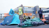 Activists from Extinction Rebellion block the entrance to the Amazon fulfilment centre in Tilbury, Essex