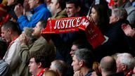 A member of the crowd holds a scarf reading &#39;justice&#39; during the Hillsborough 27th Anniversary Memorial Service at Anfield, Liverpool