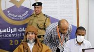 Seif al-Islam, left, the son and one-time heir apparent of late Libyan dictator Moammar Gadhafi registers his candidacy. Pic: AP