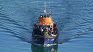 A group of people thought to be migrants are taken to Dover onboard a lifeboat following a small boat incident in the Channel on Tuesday