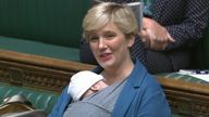 Labour MP Stella Creasy speaking in the chamber of the House of Commons with her newborn baby strapped to her