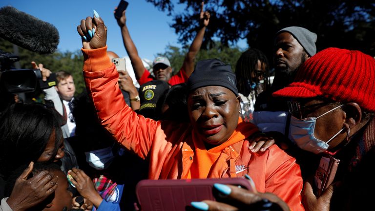 A woman raises a fist as she reacts outside the Glynn County Courthouse after the jury reached a guilty verdict in the trial of William "Roddie" Bryan, Travis McMichael and Gregory McMichael, charged with the February 2020 death of 25-year-old Ahmaud Arbery, in Brunswick, Georgia, U.S., November 24, 2021. REUTERS/Marco Bello
