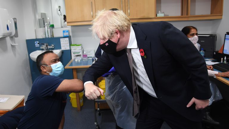 Prime Minister Boris Johnson meeting Arzou Miah, who received his booster jab on Monday, during his visit to Woodgrange GP Surgery vaccination centre in east London to meet staff and see people receiving their booster vaccines. Picture date: Monday November 15, 2021.
