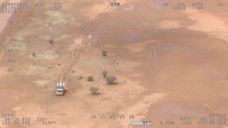 Supplies are being airdropped by authorities after torrential rain bogged a campervan, at a flooded area in the Simpson Desert, Australia November 12, 2021 in this screen grab taken from an aerial footage. Video taken November 12, 2021. Australian Maritime Safety Authority (AMSA) via REUTERS THIS IMAGE HAS BEEN SUPPLIED BY A THIRD PARTY. NO RESALES. NO ARCHIVES. MANDATORY CREDIT.
