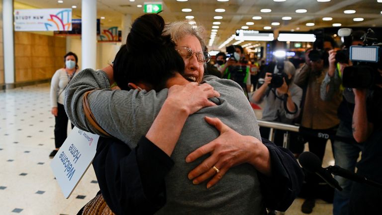 An international traveller is embraced as she arrives at Sydney Airport in the wake of coronavirus disease (COVID-19) border restrictions easing, with fully vaccinated Australians being allowed into Sydney from overseas without quarantine for the first time since March 2020, in Sydney, Australia, November 1, 2021. REUTERS/Jaimi Joy
