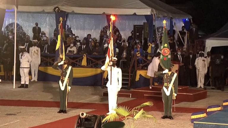 Members of the Barbados armed forces carry the presidential colours