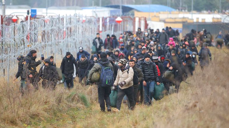 Migrants walk along the Poland-Belarus border on Friday. Pic: AP