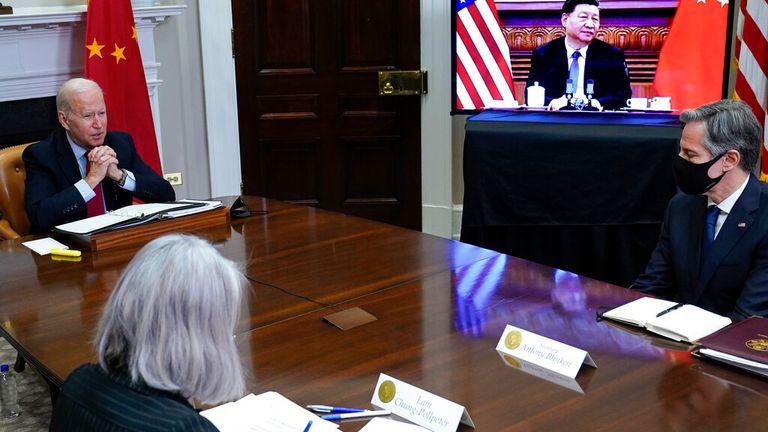 President Joe Biden meets virtually with Chinese President Xi Jinping from the Roosevelt Room of the White House in Washington, Monday, Nov. 15, 2021, as Secretary of State Antony Blinken, right, listens. (AP Photo/Susan Walsh)


