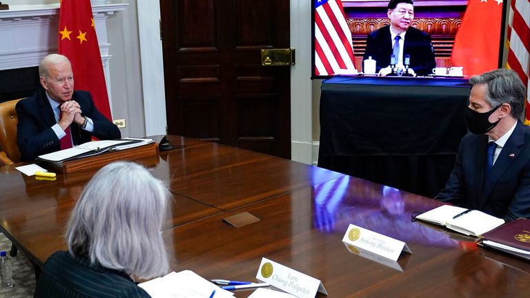 President Joe Biden meets virtually with Chinese President Xi Jinping from the Roosevelt Room of the White House in Washington, Monday, Nov. 15, 2021, as Secretary of State Antony Blinken, right, listens. (AP Photo/Susan Walsh)


