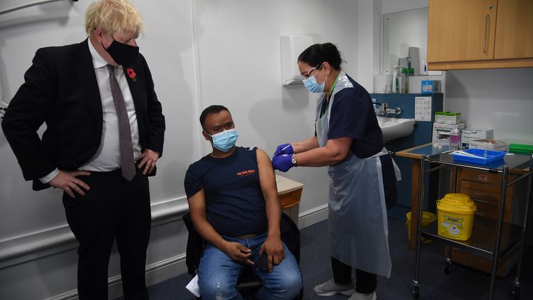 Prime Minister Boris Johnson meeting Arzou Miah, who received his booster jab on Monday, during his visit to Woodgrange GP Surgery vaccination centre in east London to meet staff and see people receiving their booster vaccines. Picture date: Monday November 15, 2021.
