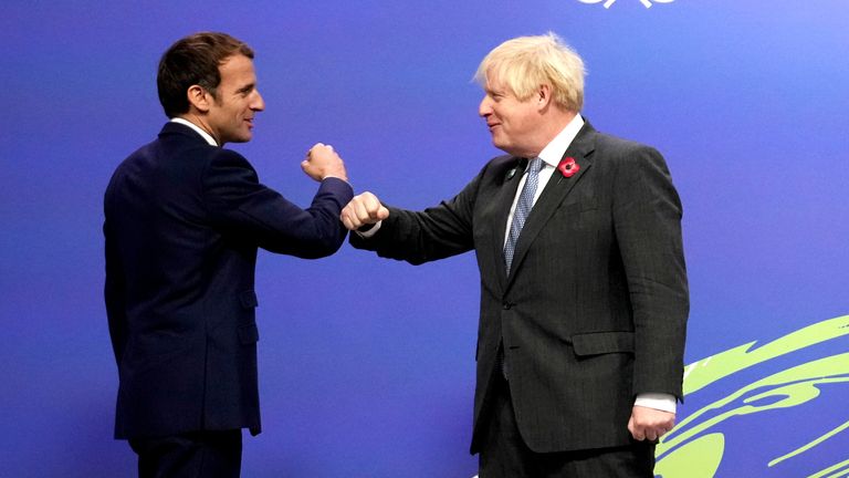 Britain's Prime Minister Boris Johnson greets France's President Emmanuel Macron during arrivals at the UN Climate Change Conference (COP26) in Glasgow, Scotland, Britain November 1, 2021. Christopher Furlong/Pool via REUTERS