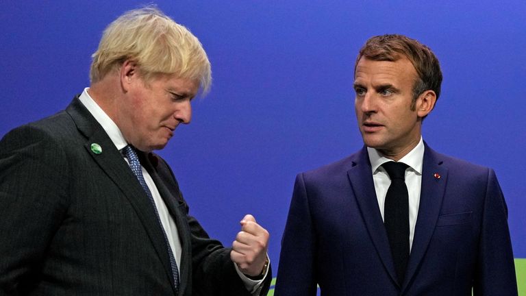 Britain&#39;s Prime Minister Boris Johnson greets France&#39;s President Emmanuel Macron during arrivals at the UN Climate Change Conference (COP26) in Glasgow, Scotland, Britain November 1, 2021. Alastair Grant/Pool 