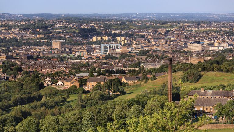 Bradford city centre - viewed from Clayton. Greenbelt land on the edge of the city of Bradford. Showing mills, houses and the city centre in the distance. 