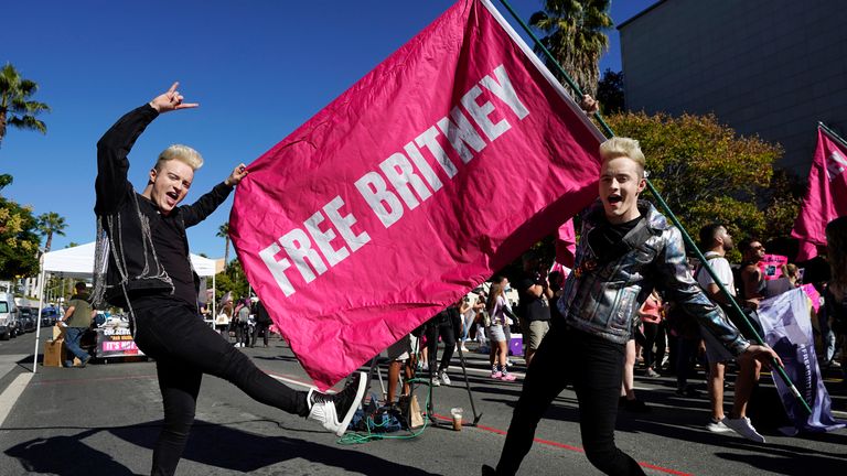 Edward, right, and John Grimes - aka Jedward - hold a 'Free Britney' flag outside a hearing on the pop singer's conservatorship at the Stanley Mosk Courthouse. Pic: AP/Chris Pizzello


